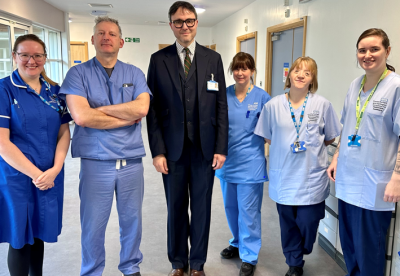 group of staff smiling outside of a hospital