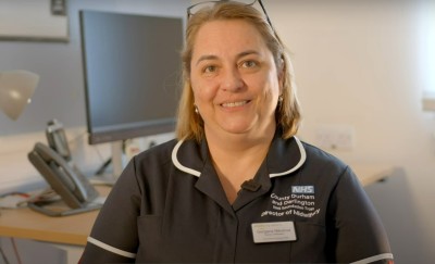 woman wearinig black nurses dress smiling