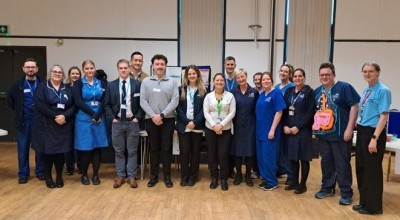 NHS staff smiling at a school