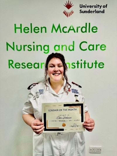 woman holding certificate and smiling