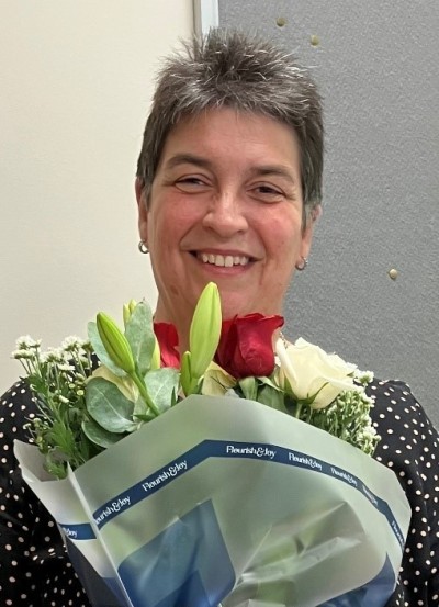 woman smiling with bunch of flowers